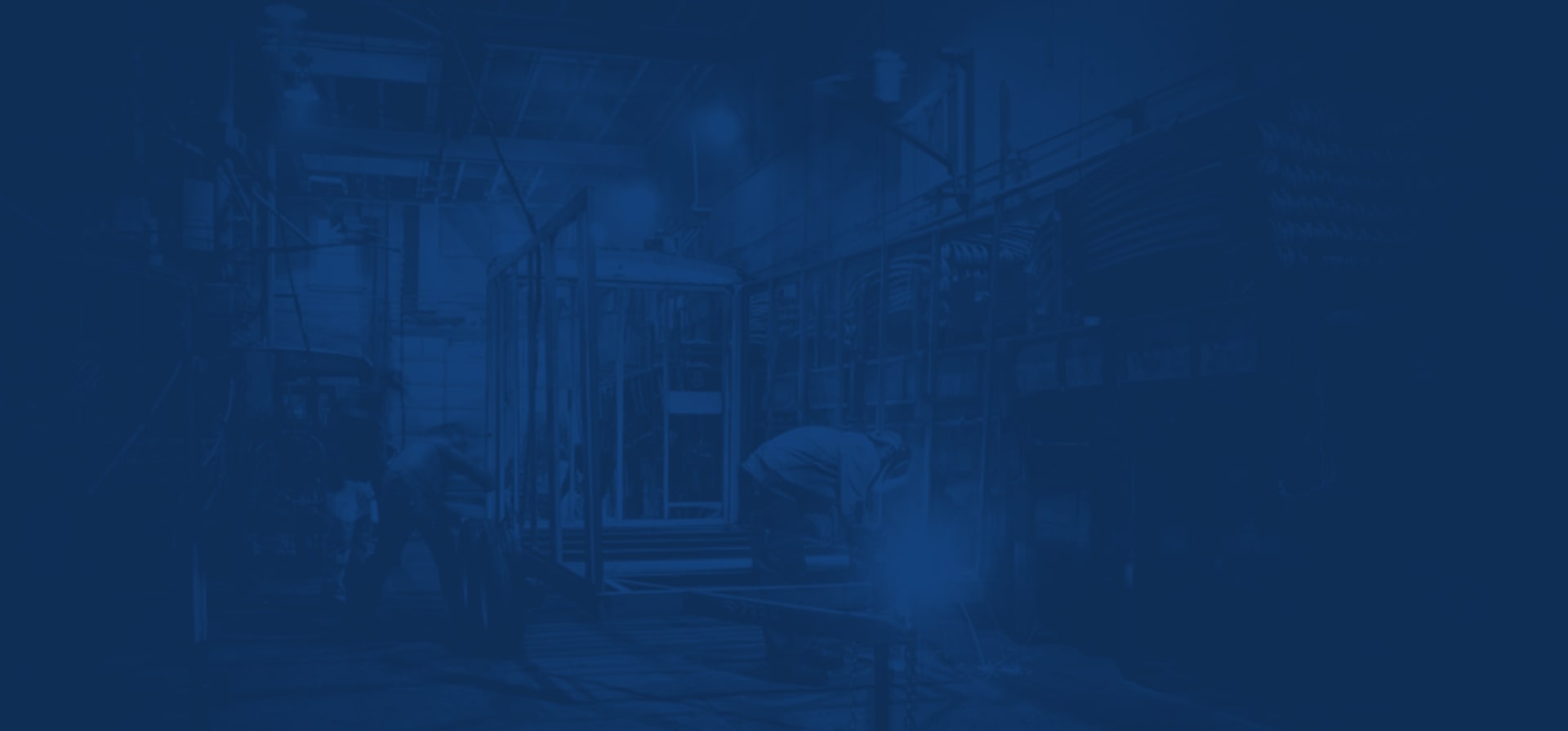 A dark blue tinted background image of two men building trailers.
